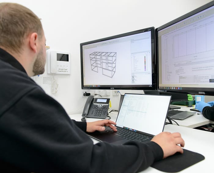 Coachbuilders employee creating CAD drawing on computer