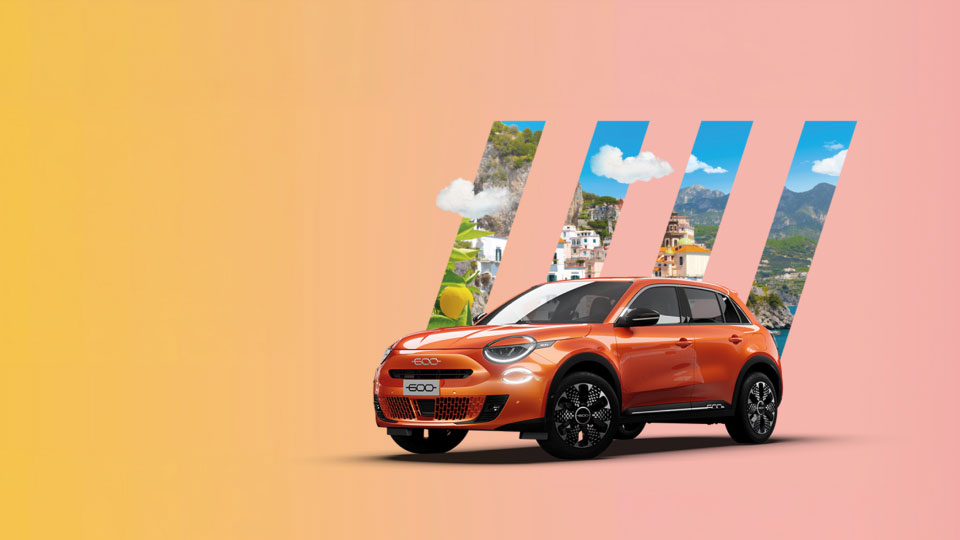 Front angled view of Fiat 600 with Italian riviera scenery in the background masked by Fiat 5 bar logo