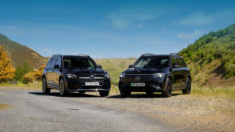 Two Mercedes-Benz SUVs in the countryside on a sunny day